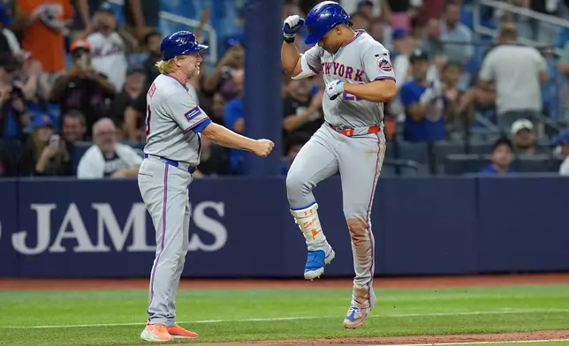New York Mets' Juan Soto, right, celebrates his home run off Tampa Bay Rays pitcher Manuel RodrÌguez with third base coach Tim Leiper during the eighth inning of a baseball game Wednesday, Sept. 2, 2026, in St. Petersburg, Fla. (AP Photo/Chris O'Meara)