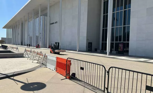Barriers are placed outside the John F. Kennedy Center for the Performing Arts on Wednesday, Sept. 16, 2026, in Washington. (AP Photo/Nathan Ellgren)
