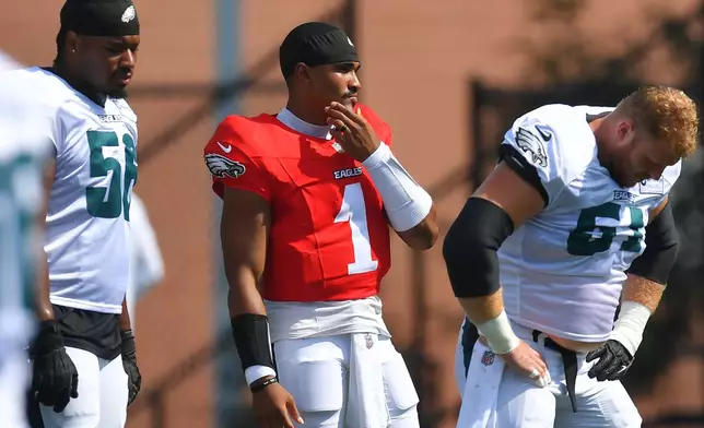 Philadelphia Eagles quarterback Jalen Hurts (1) pauses during a joint NFL football practice with the New England Patriots, Thursday, Aug. 20, 2026, in Foxborough, Mass. (AP Photo/Steven Senne)