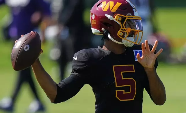 Washington Commanders quarterback Jayden Daniels (5) works out during the team's NFL football joint training camp with the Baltimore Ravens, Wednesday, Aug. 26, 2026, at the Under Armour Performance Center in Owings Mills, Md. (AP Photo/Stephanie Scarbrough)