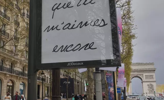 FILE - A poster featuring the French title of Céline Dion's song "If That's What It Takes," promoting autumn concerts in France on the Champs-Élysées in Paris, Wednesday, March 25, 2026. (AP Photo/Michel Euler)