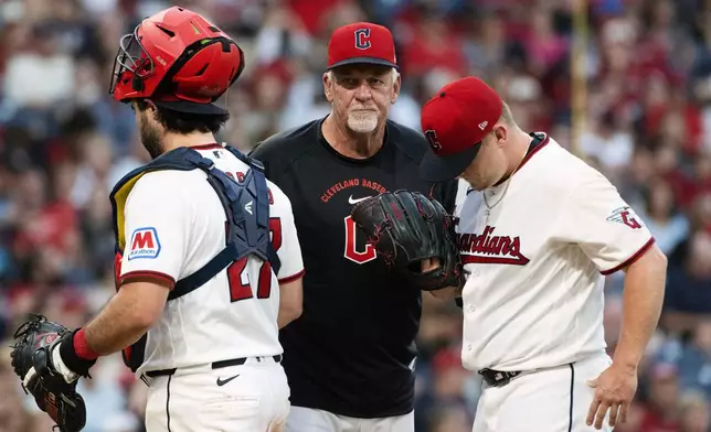 Cleveland Guardians pitching coach Carl Willis, center, has a mound meeting with starting pitcher Parker Messick, right, and catcher Austin Hedges, left, during the sixth inning of a baseball game against the Detroit Tigers, Saturday, Sept. 5, 2026, in Cleveland. (AP Photo/Phil Long)