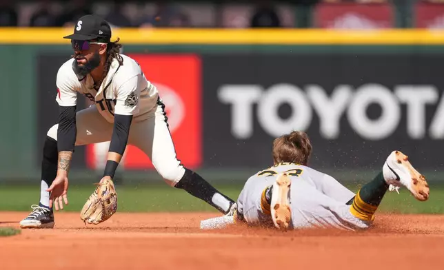Athletics' Henry Bolte, right, slides to steal second base as Seattle Mariners shortstop J.P. Crawford, left, fields the ball during the fourth inning of a baseball game, Sunday, Sept. 6, 2026, in Seattle. (AP Photo/Eric Hiller)
