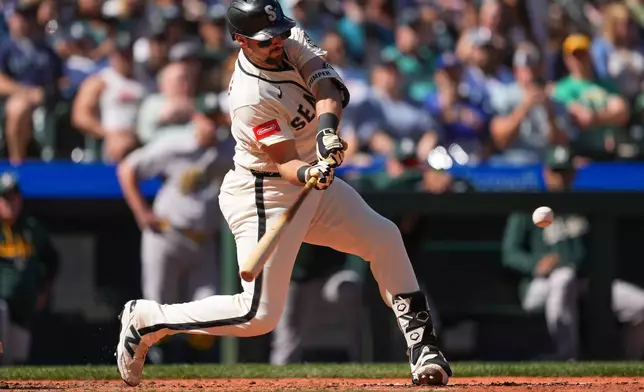 Seattle Mariners designated hitter Cal Raleigh hits an RBI single to score Dominic Canzone during the fourth inning of a baseball game against the Athletics, Sunday, Sept. 6, 2026, in Seattle. (AP Photo/Eric Hiller)