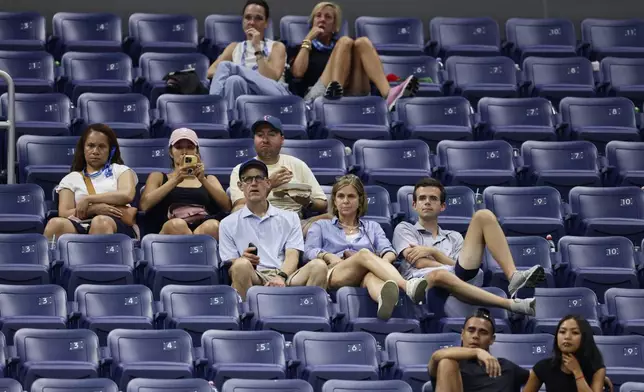 A fans watch Ben Shelton, of the United States, plays against Denis Shapovalov, of Canada, in the fourth set during the third round of the U.S. Open tennis championships, early Saturday, Sept. 5, 2026, in New York. (AP Photo/Adam Hunger)
