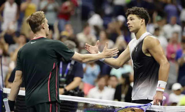 Ben Shelton, right, of the United States, shakes hands with Denis Shapovalov, of Canada, after winning in four sets in the third round of the U.S. Open tennis championships, early Saturday, Sept. 5, 2026, in New York. (AP Photo/Adam Hunger)
