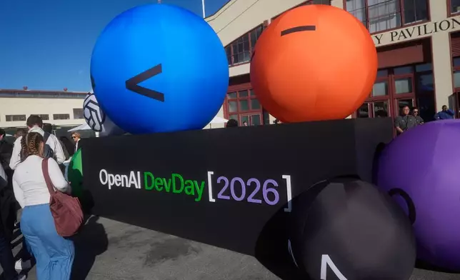 Visitors arrive for the OpenAI DevDay 2026 conference, Tuesday, Sept. 29, 2026, in San Francisco. (AP Photo/Jeff Chiu)