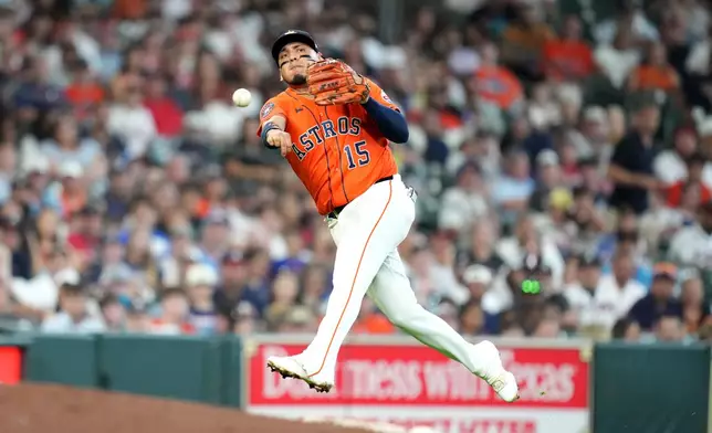 Houston Astros third baseman Isaac Paredes tries to make a throw to first base as Atlanta Braves' Ronald Acuna Jr. singled during the fifth inning of a baseball game, Sunday, Sept. 20, 2026, in Houston. (AP Photo/Karen Warren)