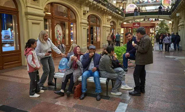 FILE - Shoppers rest at the GUM Department store near Red Square in Moscow, Monday, Aug. 25, 2025. (AP Photo/Alexander Zemlianichenko, File)