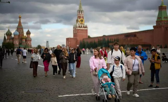 FILE - People walk through Red Square in Moscow on Monday, Aug. 24, 2026, near St. Basil's Cathedral, left, and the Spasskaya Tower, center. (AP Photo/Alexander Zemlianichenko, File)