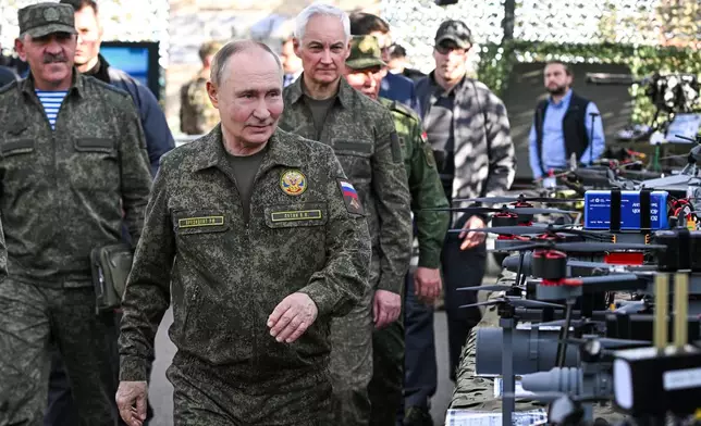 FILE - Russian President Vladimir Putin, accompanied by Deputy Defense Minister Yunus-Bek Yevkurov, left, and Defense Minister Andrei Belousov, right, inspects weapons and equipment during military drills at the Mulino training ground in the Nizhny Novgorod region of Russia on Tuesday, Sept. 16, 2025. (Sergey Bobylev/Sputnik, Kremlin Pool Photo via AP, File)