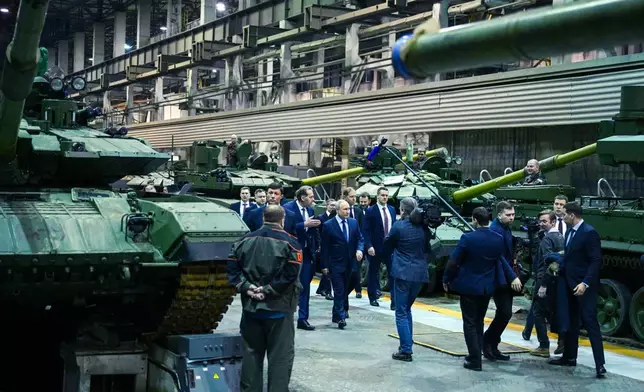 FILE - Russian President Vladimir Putin, center, visits the Uralvagonzavod factory in Nizhny Tagil, Russia, on Thursday, Feb. 15, 2024. (Ramil Sitdikov, Sputnik, Kremlin Pool Photo via AP, File)