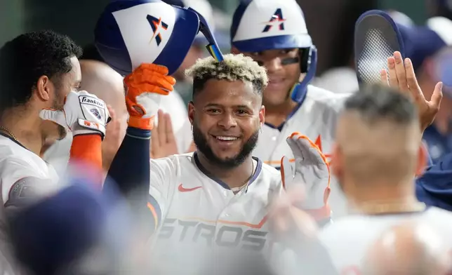 Houston Astros' Nelson Velázquez celebrates in the dugout after hitting a two-run home run against the Chicago White Sox during the fourth inning of a baseball game Monday, Aug. 31, 2026, in Houston. (AP Photo/David J. Phillip)