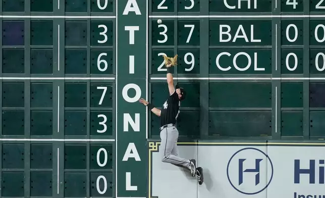 Chicago White Sox left fielder Sam Antonacci tries to catch a single by Houston Astros' Isaac Paredes during the fifth inning of a baseball game Monday, Aug. 31, 2026, in Houston. (AP Photo/David J. Phillip)