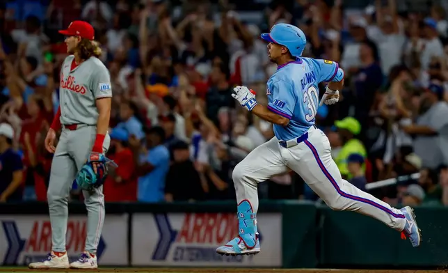 Atlanta Braves designated hitter Drake Baldwin, right, rounds first base after hitting a two-run double against the Philadelphia Phillies during the fourth inning of a baseball game, Saturday, Sept. 12, 2026, in Atlanta. (AP Photo/Erik S. Lesser)