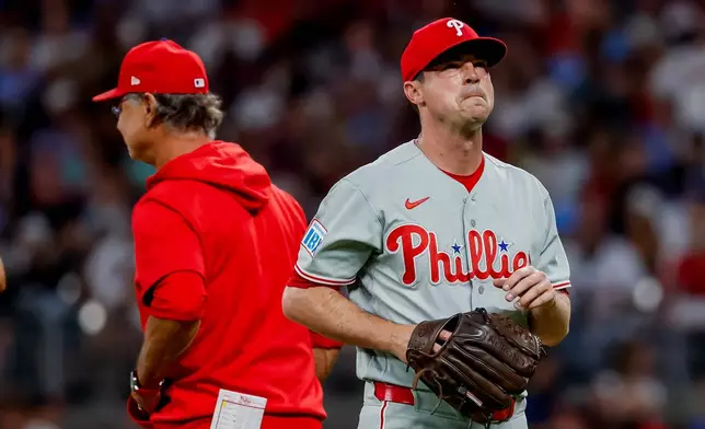Philadelphia Phillies pitcher Brooks Raley, right reacts after getting relieved by interim manager Don Mattingly during the fourth inning of a baseball game against the Atlanta Braves, Saturday, Sept. 12, 2026, in Atlanta. (AP Photo/Erik S. Lesser)