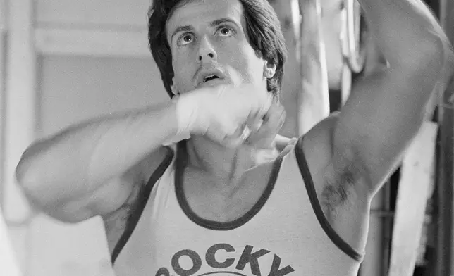 FILE - Sylvester Stallone works over a punching bag in Los Angeles, Feb. 9, 1981. (AP Photo/Randy Rasmussen, File)