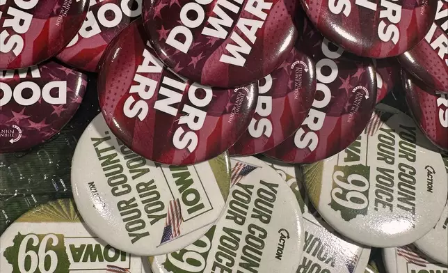 Turning Point Action gives out buttons at the Iowa State Fair in Des Moines, Iowa, Friday, Aug. 21, 2026. (AP Photo / Hannah Fingerhut)