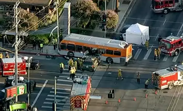 In this still image provided by KABC-TV shows firefighters respond to a deadly bus crash, in Los Angeles on Tuesday, Sept. 15, 2026. (KABC-TV via AP)