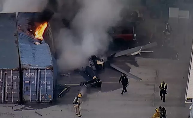 In this still image provided by KABC-TV shows first responders work the scene after a helicopter crashed near a bus crash in Chatsworth, a neighborhood in Los Angeles, Tuesday, Sept. 15, 2026. (KABC-TV via AP)