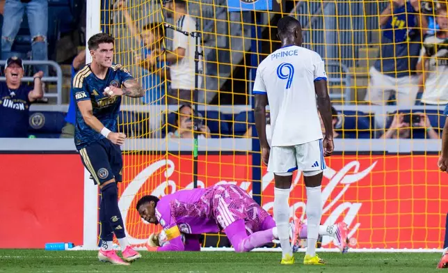 Philadelphia Union's Jovan Lukic, left, reacts to goalie Andre Blake, bottom, making a save against a penalty kick by CF Montreal's Prince Owusu (9) during the second half of an MLS soccer match, Saturday, Sept. 5, 2026, in Chester, Pa. (AP Photo/Chris Szagola)
