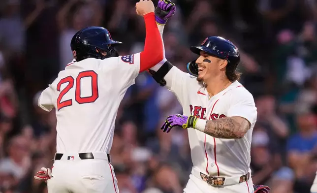 Boston Red Sox's Jarren Duran, right, is congratulated by Nick Sogard (20) after hitting a two-run home run during the second inning of a baseball game against the Seattle Mariners, Monday, Aug. 31, 2026, in Boston. (AP Photo/Charles Krupa)