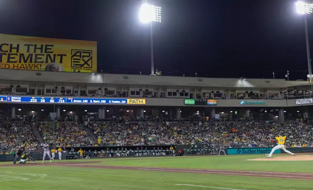 Houston Astros' Christian Walker, third from left, takes an at-bat and hits a double during the sixth inning of a baseball game against the Athletics, Saturday, Sept. 26, 2026, in West Sacramento, Calif. (AP Photo/Sara Nevis)