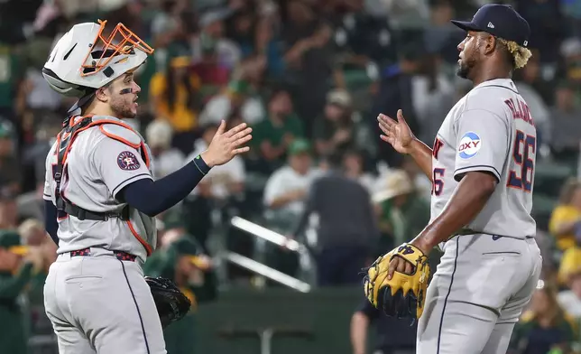 Houston Astros catcher Yainer Diaz, left, high-fives pitcher Ronel Blanco after a baseball game against the Athletics Saturday, Sept. 26, 2026, in West Sacramento, Calif. (AP Photo/Sara Nevis)