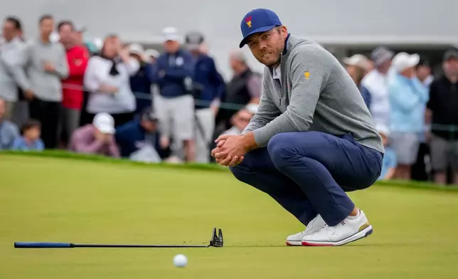 USA teams' Sam Burns reacts after missing his birdie putt on the 18th green to lose to the International team during the Presidents Cup golf tournament second round foursomes match at Medinah Country Club, Friday, Sept. 25, 2026, in Medinah, Ill. (AP Photo/Chris Carlson)