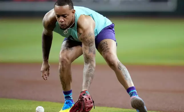 Returning Arizona Diamondbacks' Ketel Marte takes early infield practice prior to a baseball game against the Philadelphia Phillies, Monday, Aug. 31, 2026, in Phoenix. (AP Photo/Ross D. Franklin)