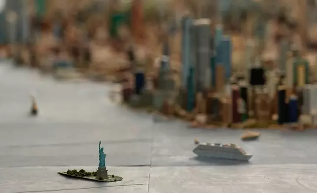 The Statue of Liberty is seen on a large model of the New York City, made by Joe Macken, at the Museum of the City of New York in New York, Monday, Sept. 14, 2026. (AP Photo/Seth Wenig)