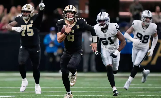 New Orleans Saints quarterback Tyler Shough (6) runs the ball as Las Vegas Raiders' Malcolm Koonce (51) gives chase during the first half of an NFL football game in New Orleans, Sunday, Sept. 27, 2026. (AP Photo/Gerald Herbert)