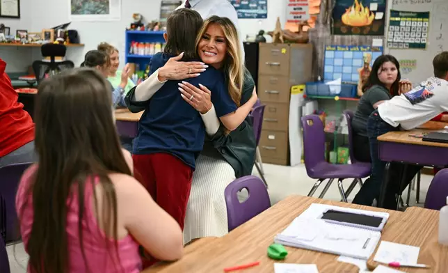 First Lady Melania Trump embraces a student at Mountain View Elementary School in Jefferson, N.C., Tuesday, Sept. 15, 2026. (Kent Nishimura/Pool Photo via AP)
