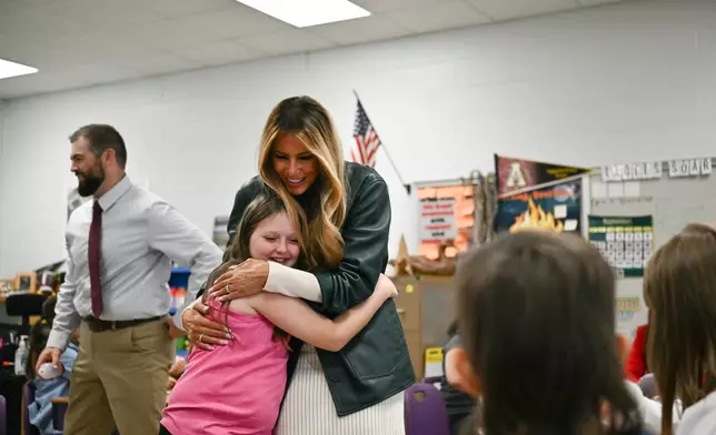 First Lady Melania Trump embraces a student at Mountain View Elementary School in Jefferson, N.C., Tuesday, Sept. 15, 2026. (Kent Nishimura/Pool Photo via AP)