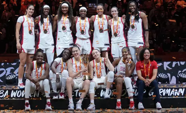 United States plyers pose on the podium after winning the Women's Basketball World Cup final match between the United States and France in Berlin, Sunday, Sept. 13, 2026. (AP Photo/Ebrahim Noroozi)