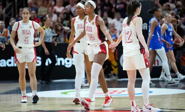 Angel Reese, of the United States, left, and Caitlin Clark of the United States, touch hands during the Women's Basketball World Cup final match between the United States and France in Berlin, Sunday, Sept. 13, 2026. (AP Photo/Ebrahim Noroozi)