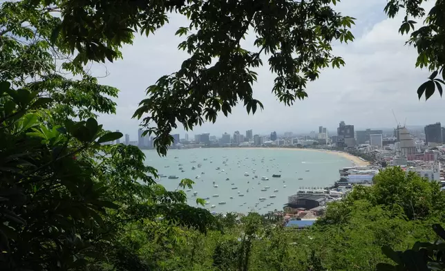 Boats float by Pattaya beach in Thailand, Tuesday, Sept. 1, 2026. (AP Photo/Sakchai Lalit)