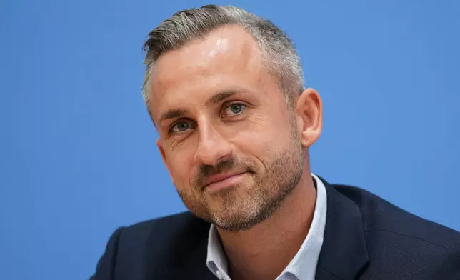 Top candidate for the Saxony-Anhalt state elections Ulrich Siegmund, center, attends a press conference in Berlin, Germany, Monday, Sept. 7, 2026. (AP Photo/Ebrahim Noroozi)