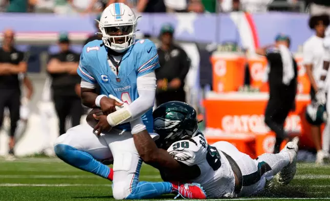 Tennessee Titans quarterback Cam Ward (1) is sacked by Philadelphia Eagles defensive tackle Jalen Carter (98) during the second half of an NFL football game, Sunday, Sept. 20, 2026, in Nashville, Tenn.(AP Photo/George Walker IV)