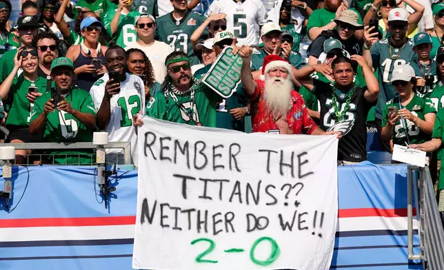 Philadelphia Eagles fans celebrate during the second half of an NFL football game against the Tennessee Titans, Sunday, Sept. 20, 2026, in Nashville, Tenn.(AP Photo/George Walker IV)