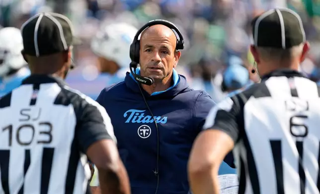 Tennessee Titans head coach Robert Saleh, center, talks with officials during the second half of an NFL football game against the Philadelphia Eagles, Sunday, Sept. 20, 2026, in Nashville, Tenn.(AP Photo/George Walker IV)