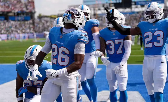 Tennessee Titans cornerback Marcus Harris (26) celebrates with teammates after intercepting a pass during the second half of an NFL football game against the Philadelphia Eagles, Sunday, Sept. 20, 2026, in Nashville, Tenn.(AP Photo/George Walker IV)