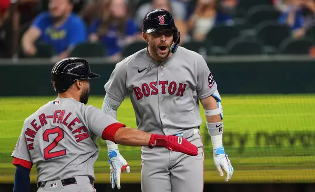 Boston Red Sox's Isiah Kiner-Falefa (2) and Trevor Story, right, celebrate Story's three-run home run in the eighth inning of a baseball game against the Texas Rangers Thursday, Sept. 17, 2026, in Arlington, Texas (AP Photo/Tony Gutierrez)