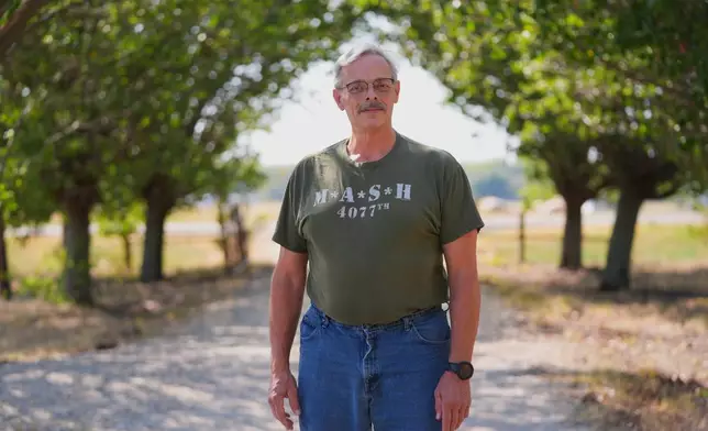 Ed Westrick, 59, poses for a photo at his home's driveway near Commerce, Texas, Friday, Sept. 18, 2026. (AP Photo/LM Otero)