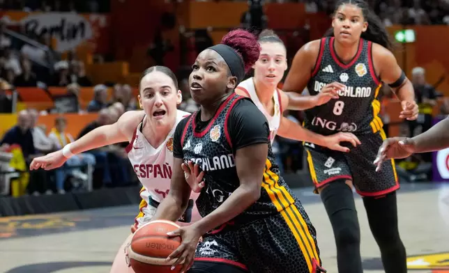 Spain's Iyana Martín fouls Germany's Alexis Peterson during the Women's Basketball World Cup the third-place match between the Germany and Spain in Berlin, Sunday, Sept. 13, 2026. (AP Photo/Ebrahim Noroozi)