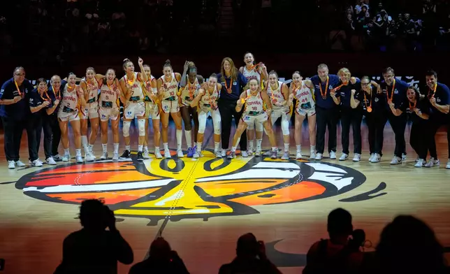 Spanish team poses with medals aafter the Women's Basketball World Cup third-place match between the Germany and Spain in Berlin, Sunday, Sept. 13, 2026. (AP Photo/Ebrahim Noroozi)