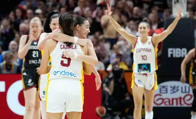 Spain's Maite Cazorla and Iyana Martín hug during the Women's Basketball World Cup the third-place match between the Germany and Spain in Berlin, Sunday, Sept. 13, 2026. (AP Photo/Ebrahim Noroozi)