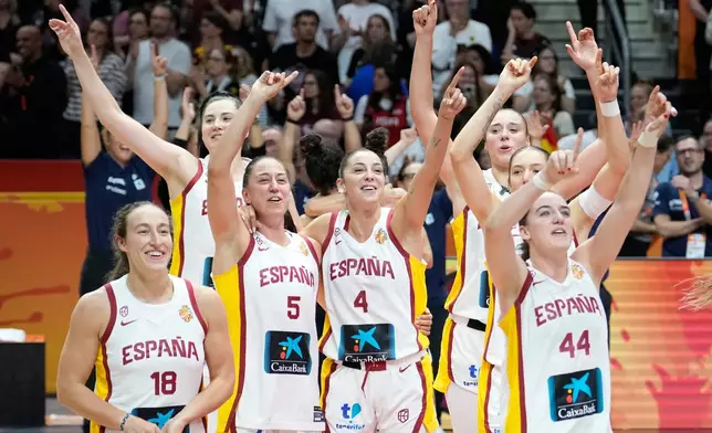 Spanish players celebrate after the Women's Basketball World Cup third-place match between the Germany and Spain in Berlin, Sunday, Sept. 13, 2026. (AP Photo/Ebrahim Noroozi)