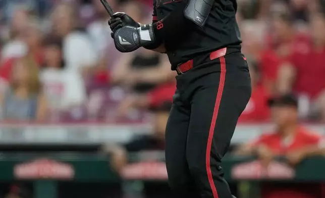 Cincinnati Reds' Eugenio Suárez watches his three-run homer in the third inning of a baseball game against the Milwaukee Brewers, Friday, Sept. 4, 2026, in Cincinnati. (AP Photo/Carolyn Kaster)