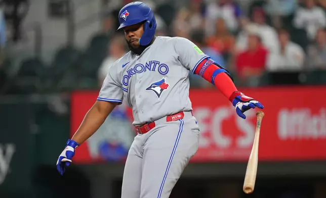 Toronto Blue Jays' Vladimir Guerrero Jr. reacts after striking out swinging against Texas Rangers starting pitcher Kumar Rocker during the first inning of a baseball game Friday, Sept. 18, 2026, in Arlington, Texas. (AP Photo/Julio Cortez)